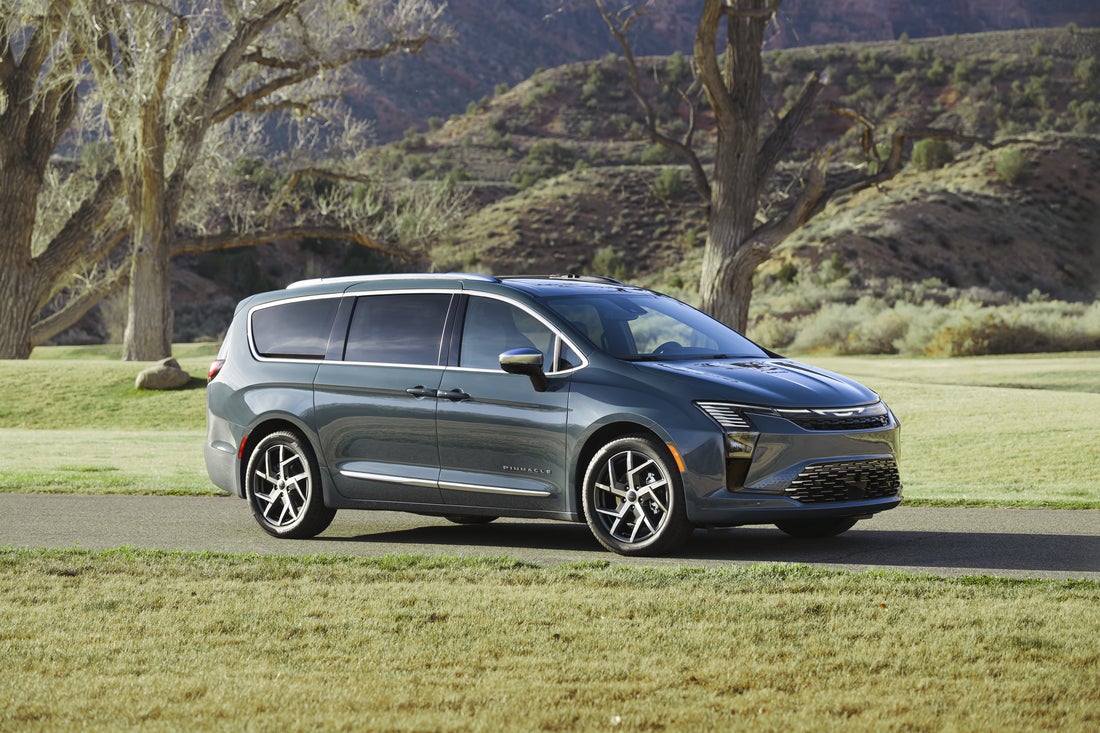 2027 Chrysler Pacifica Pinnacle front three-quarter profile showing redesigned front fascia and 20-inch machined wheels