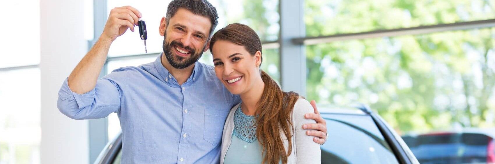 Couple Posing with New Vehicle Keys Snipped